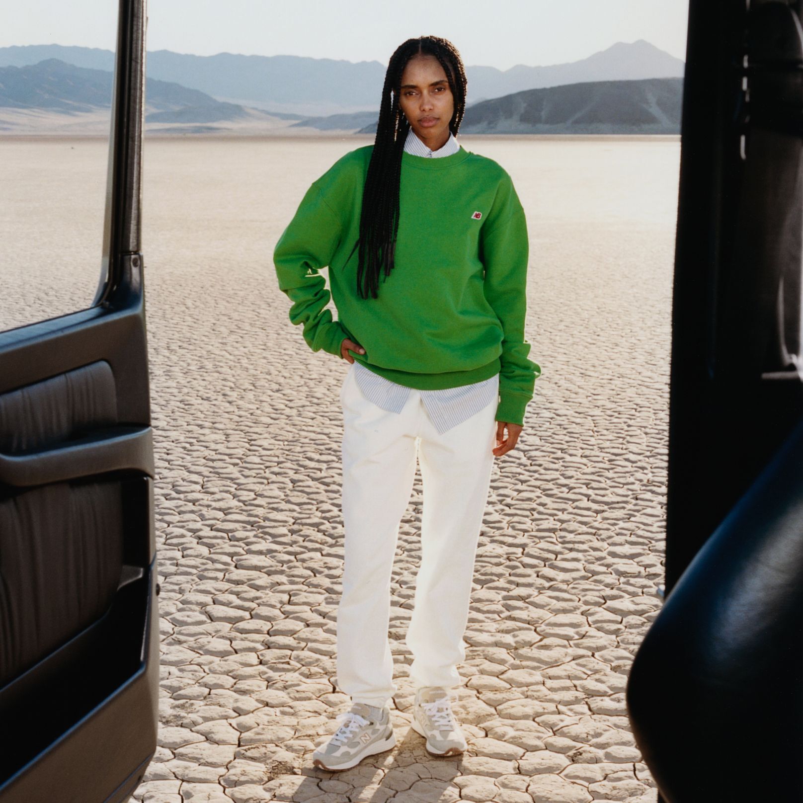 A man standing in a desert environment. 